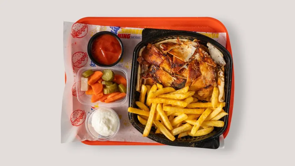 A fast-food meal tray with fried chicken and french fries, illustrative photo